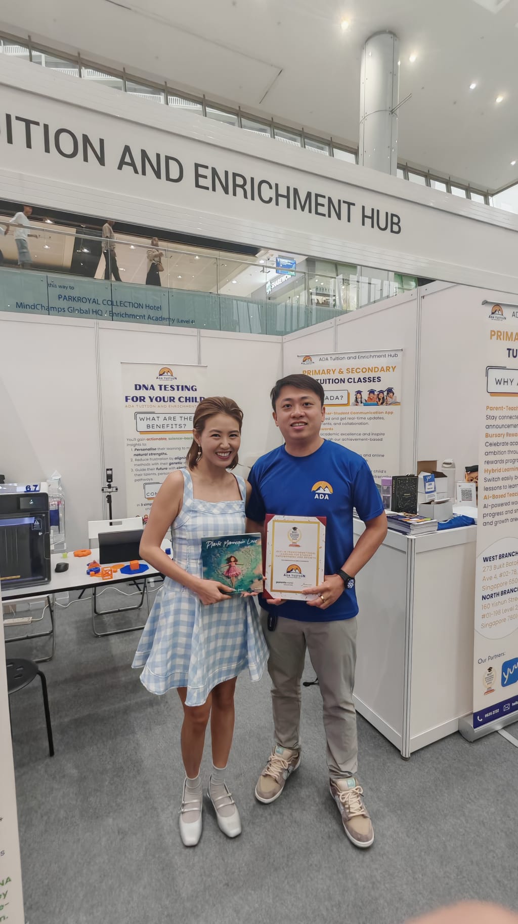 ADA Tuition team holding the Parents World 2025 award at the ADA booth