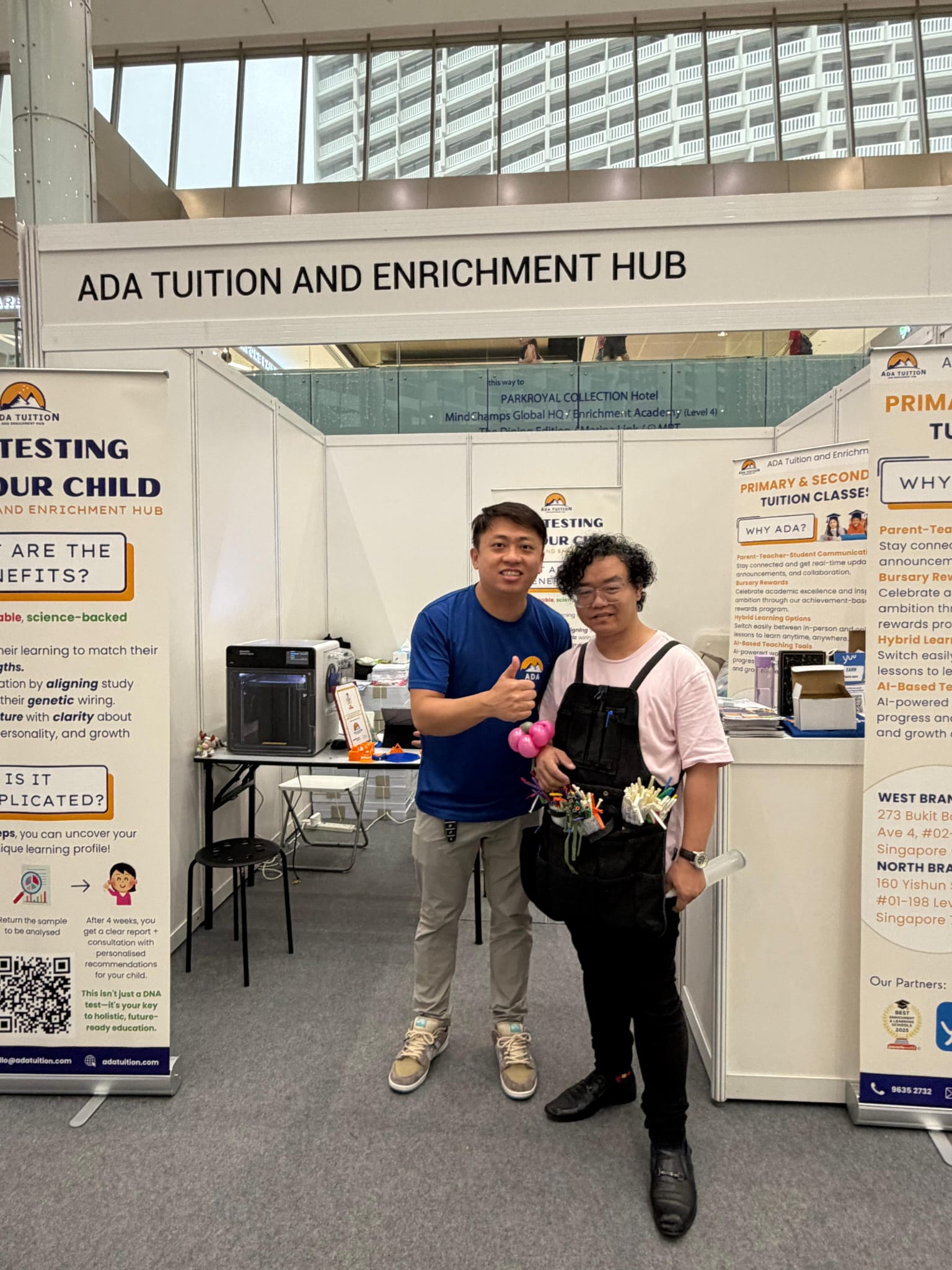 ADA Tuition founder with a visitor at the Parents World Fair 2025 booth