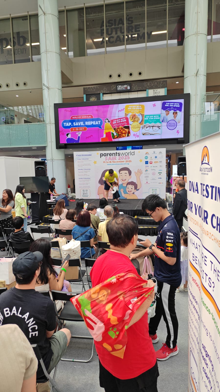 Parents and children at the ADA Tuition booth during Parents World Fair 2025
